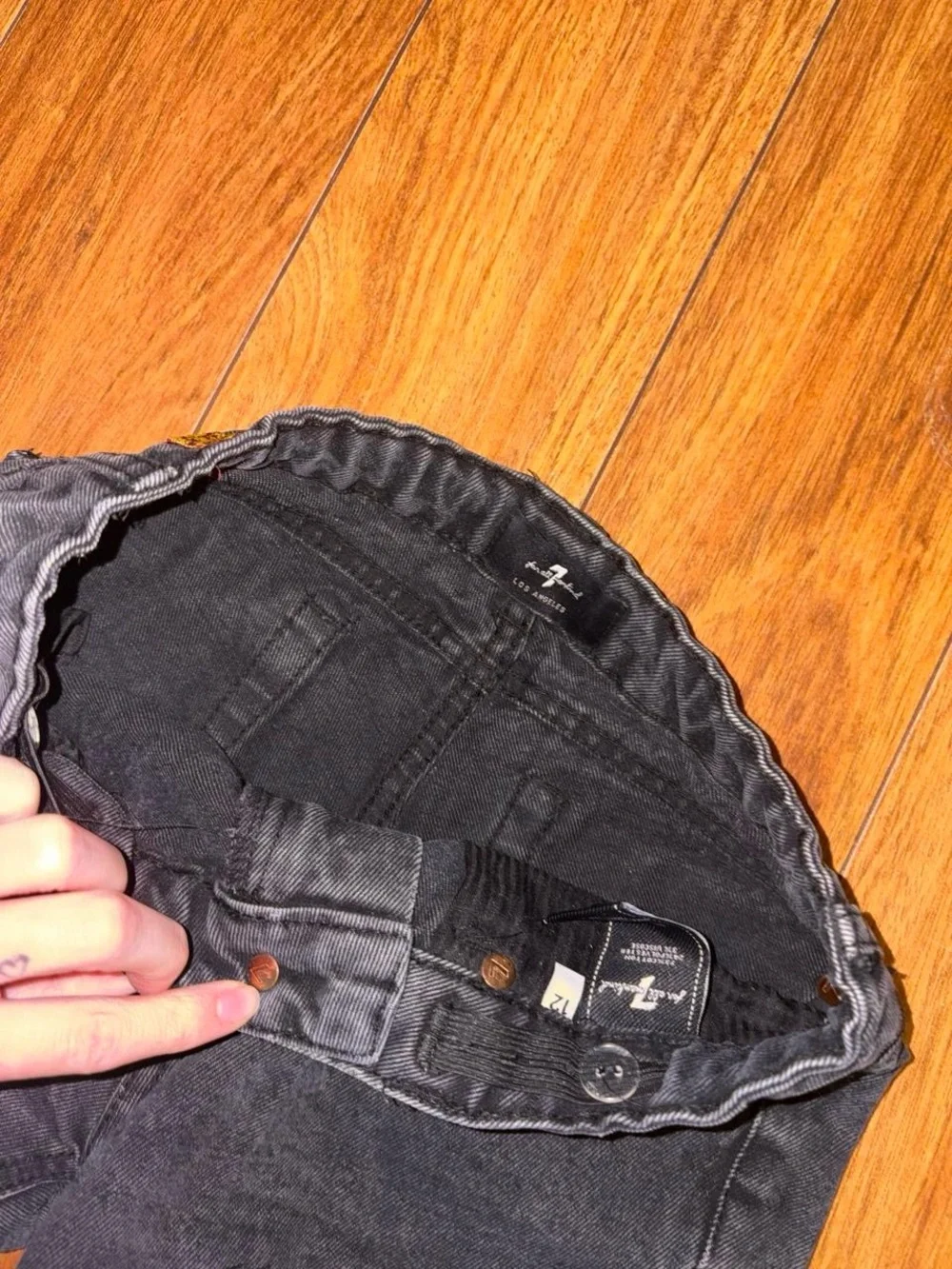 Black denim shorts with a distressed look
